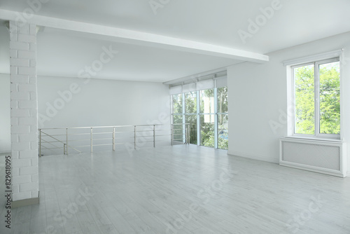 Large empty hall with windows and railings