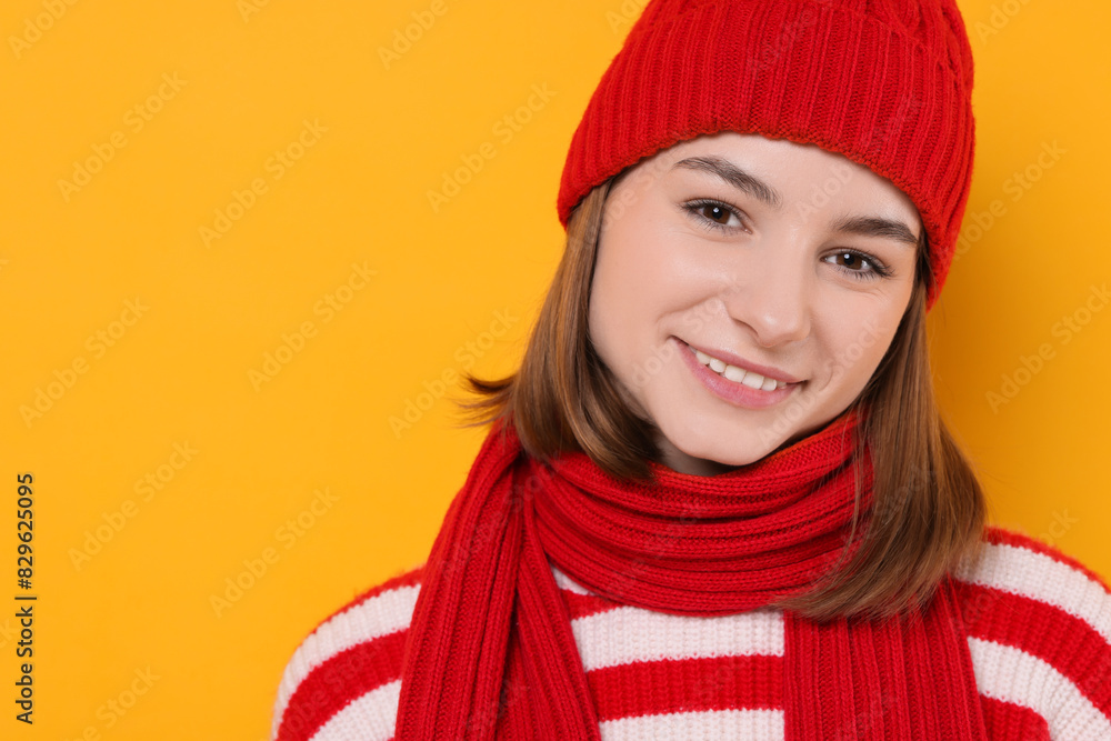 Beautiful woman in warm scarf on yellow background, space for text Beautiful woman in warm scarf on yellow background, space for text