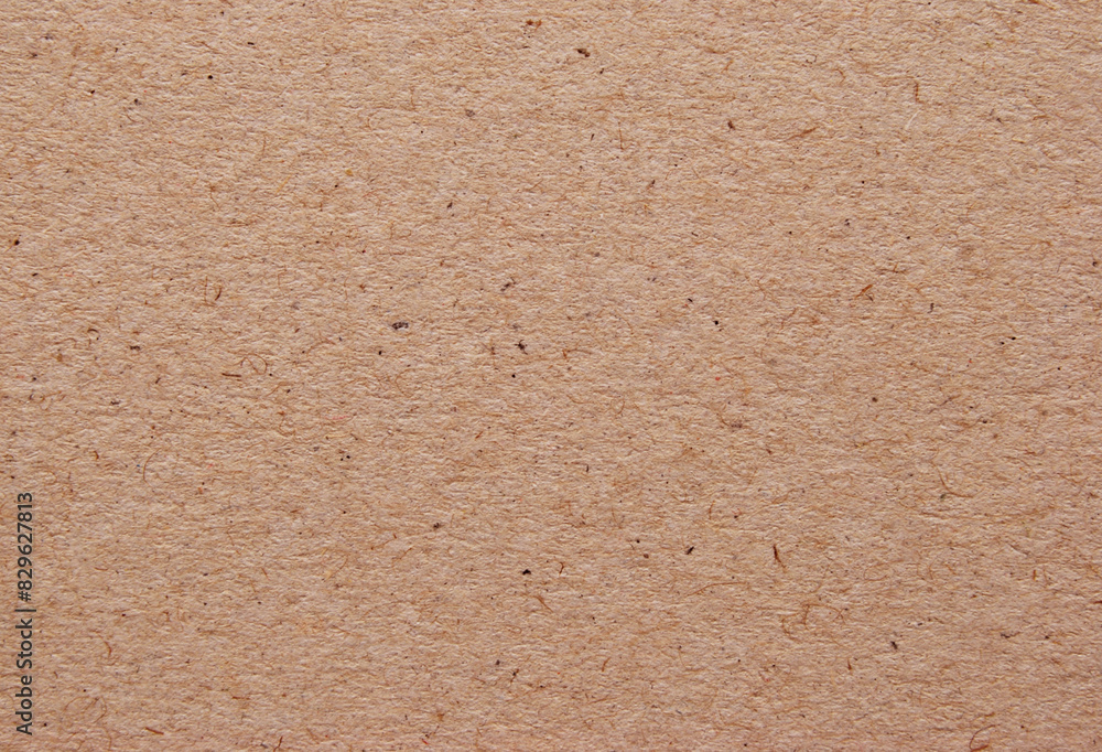 A sheet of brown recycled cardboard texture as background A sheet of brown recycled cardboard texture as background