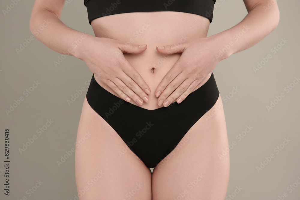 Fototapeta premium Gynecology. Woman in underwear on grey background, closeup