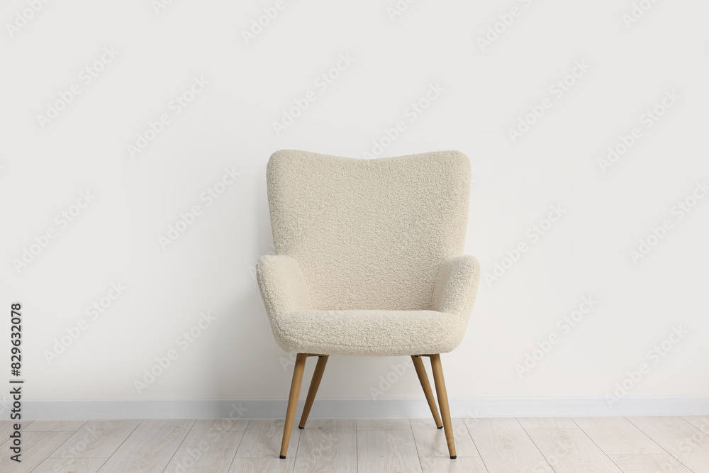Fototapeta premium Comfortable armchair near white wall in room