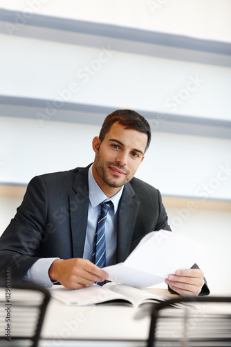 Business man, portrait and paperwork for financial accounting, expenses and budget report in office. Corporate worker, accountant or auditor with documents for bookkeeping of company taxes or revenue