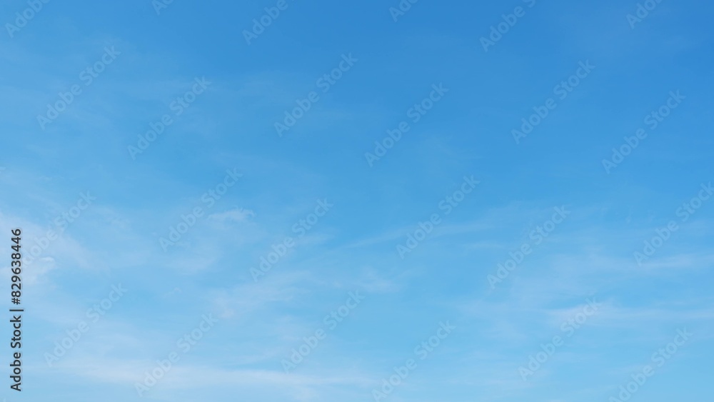 A clear blue sky with a few faint, wispy clouds. The sky is bright and expansive, suggesting a calm and pleasant day with excellent visibility. Horizon background.

