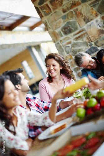 Happy, family and healthy brunch at table together for wellness, corn and salad for nutrition. Diversity, Man and woman with vegetables in home or memories and fresh fruit in diet, eating with smile © peopleimages.com