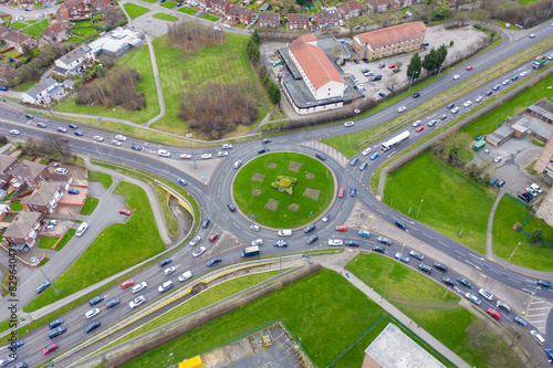 Aerial drone photo of the town of Seacroft in Leeds West Yorkshire UK showing a roundabout and busy roads in the winter time opposite a hotel