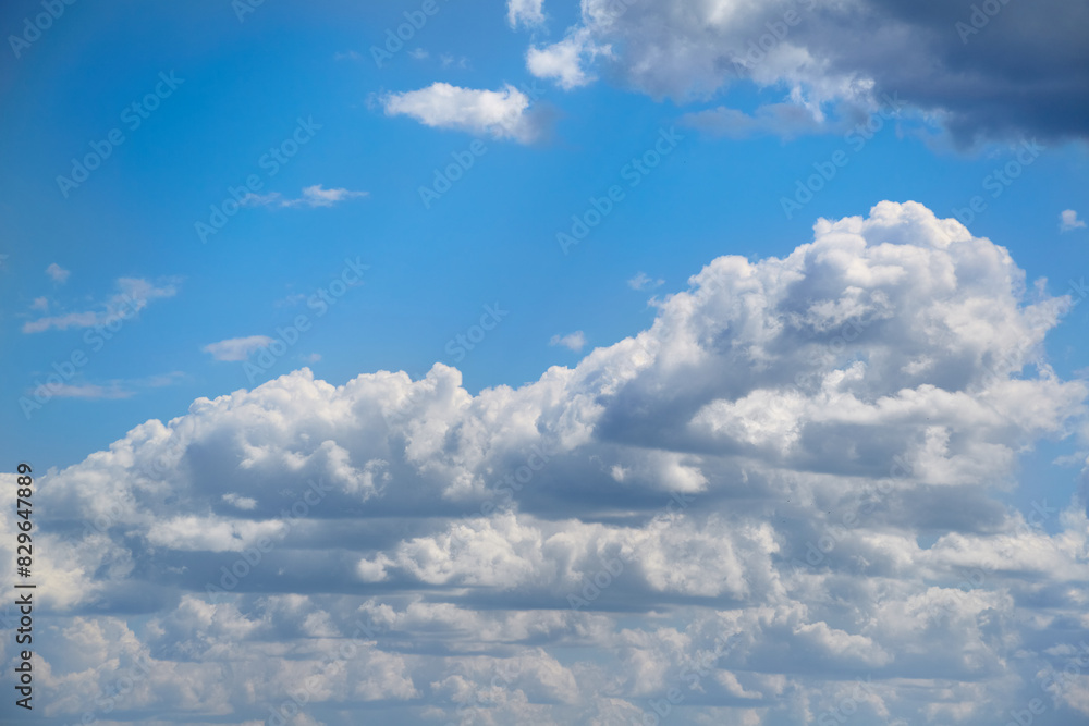 Large white clouds in a single row in the sky, blue sky with clouds Large white clouds in a single row in the sky, blue sky with clouds