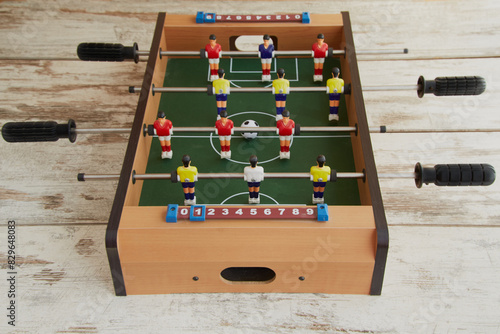 Mini table sport soccer close-up, children's table soccer on wooden table