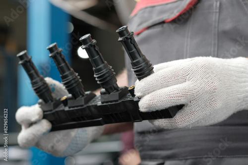 Spare parts.Car service.The cassette with ignition coils is new.Close-up. An auto mechanic monitors the integrity of the spare part before installing it on the engine.