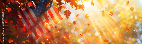 Flag United States America strewn with yellowed autumn maple leaves and bunch wheat ears with blurred background
