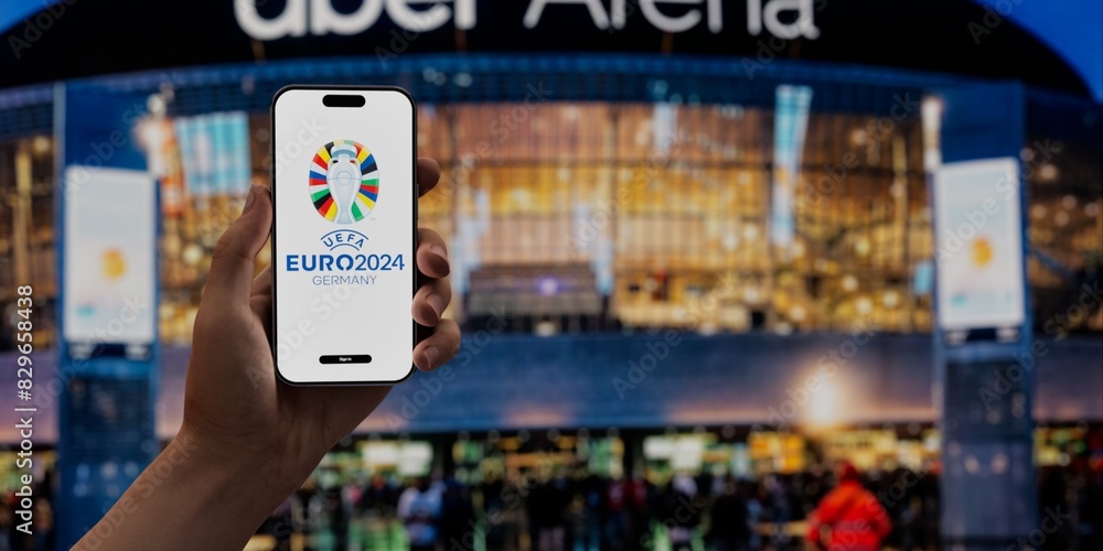 Fan holding a phone with the UEFA Euro 2024 app on a screen, against ...