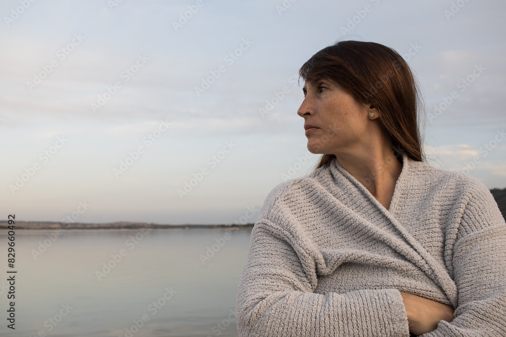 woman looking calm and relaxed towards, horizon alone on the coast. World Mental Health Day. Feeling. emotion concept. Horizontal. woman looking calm and relaxed towards, horizon alone on the coast. World Mental Health Day. Feeling. emotion concept. Horizontal.