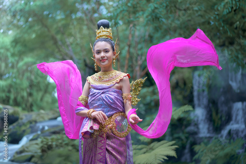 Beautiful girl in a Kinnari dress in green natural with the moss and mist. Kinnari is an animal in the Himmapan forest in Thai literature. photo