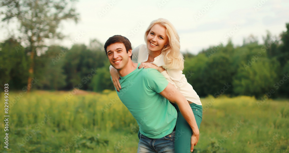 Portrait of beautiful happy smiling young couple in love together hugging in summer park Portrait of beautiful happy smiling young couple in love together hugging in summer park