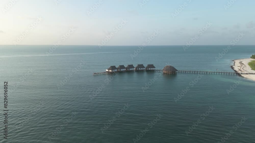 Aerial view towards luxurious thatched roof Kae Funk chalets Indian ocean beach resort in Zanzibar Chwaka bay Aerial view towards luxurious thatched roof Kae Funk chalets Indian ocean beach resort in Zanzibar Chwaka bay