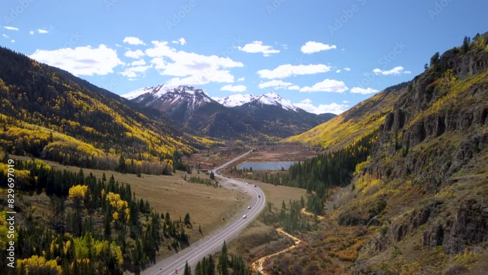 Million Dollar Highway (US 550) running through the Rocky Mountains lined with golden aspen trees in the fall to snowcapped mountains Million Dollar Highway (US 550) running through the Rocky Mountains lined with golden aspen trees in the fall to snowcapped mountains