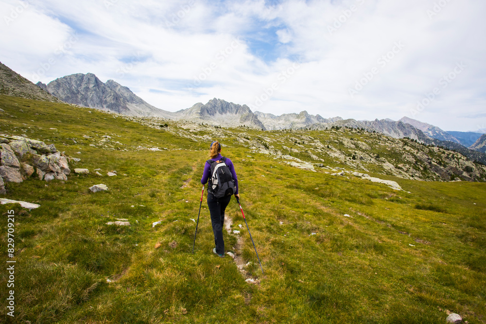 Young hiker woman in Vall de Boi, Aiguestortes and Sant Maurici National Park, Spain Young hiker woman in Vall de Boi, Aiguestortes and Sant Maurici National Park, Spain