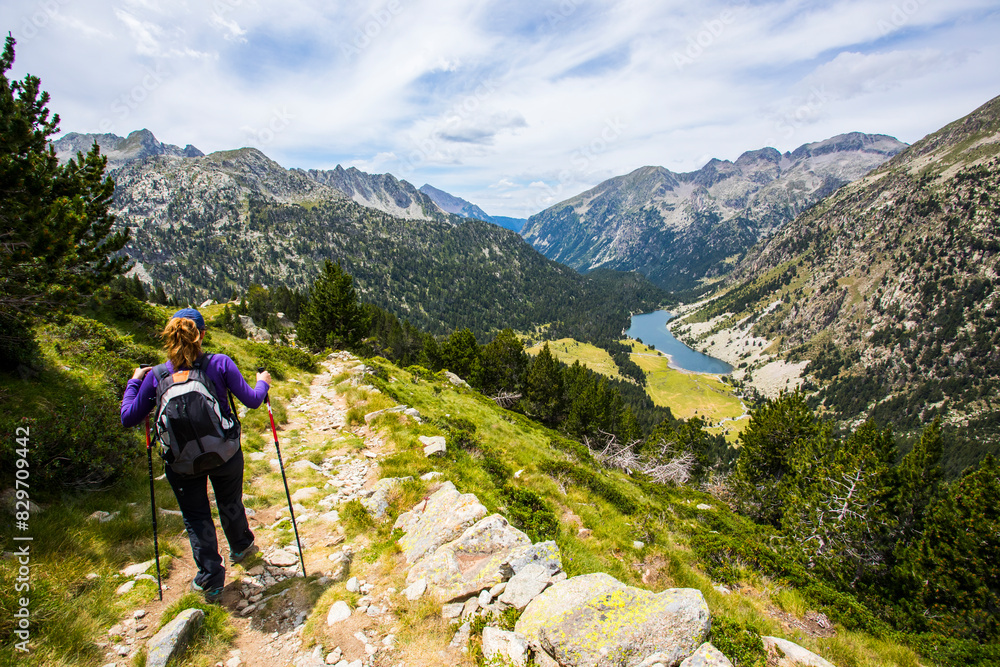 Fototapeta premium Young hiker woman in Vall de Boi, Aiguestortes and Sant Maurici National Park, Spain