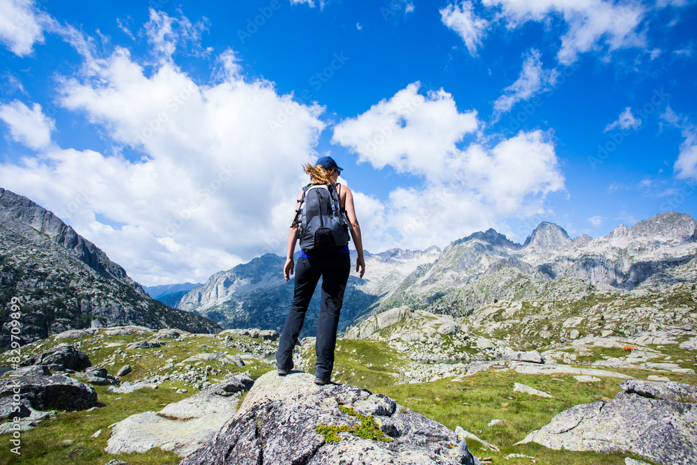 Fototapeta premium Young hiker woman in Vall de Boi, Aiguestortes and Sant Maurici National Park, Spain