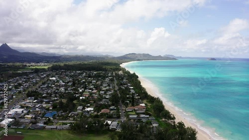 Aerial view of Oahu's shoreline with houses going all the way up to the coastline. photo