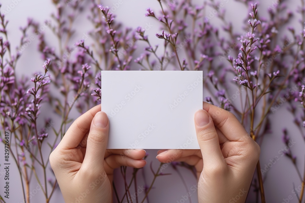 Hands hold a blank card with floral background. Hands hold a blank card with floral background.