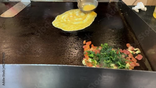 They spooned the egg onto the griddle to cook an omelet in a buffet-style restaurant of a large all-inclusive luxury resort hotel in the Caribbean.