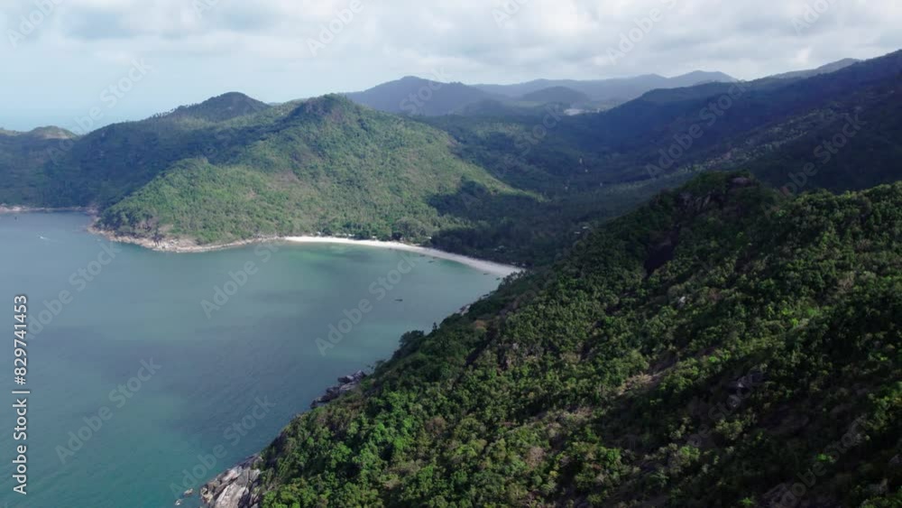 Fly over green mountains towards bottle beach at Koh Phangan, Thailand Fly over green mountains towards bottle beach at Koh Phangan, Thailand