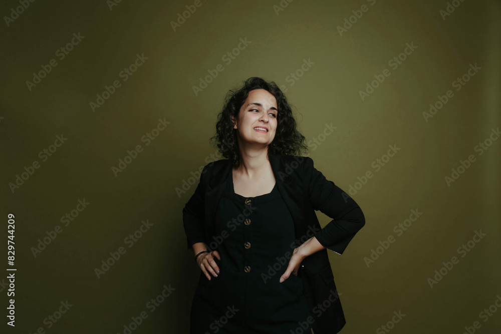 Fashionable woman posing against a vibrant red wall Fashionable woman posing against a vibrant red wall