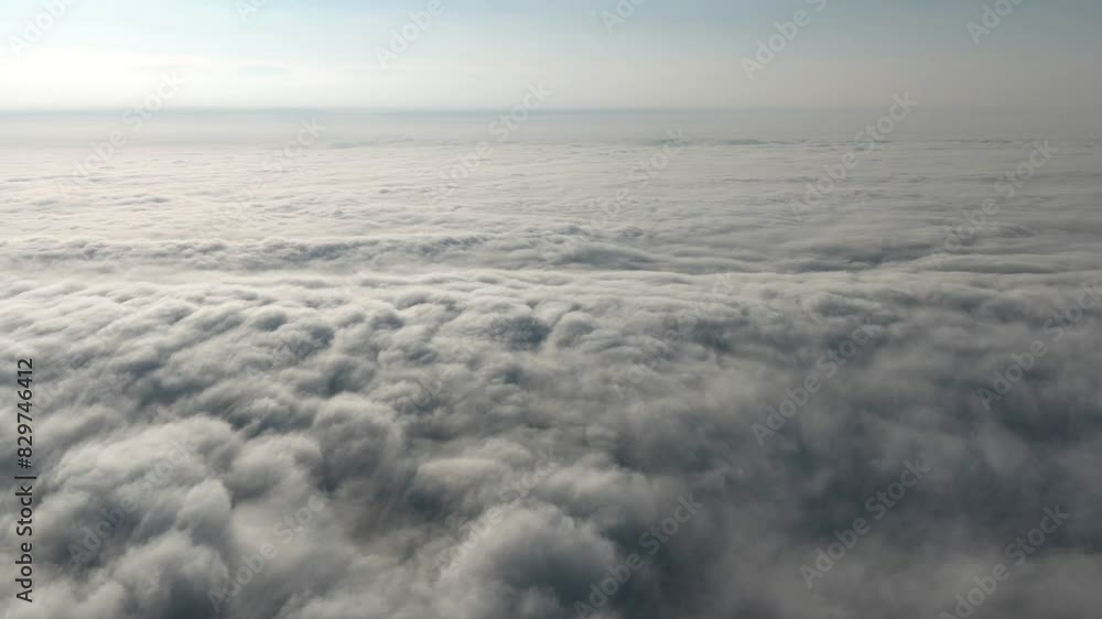 Aerial hyperlapse above the dense fog with sunny sky in the background Aerial hyperlapse above the dense fog with sunny sky in the background