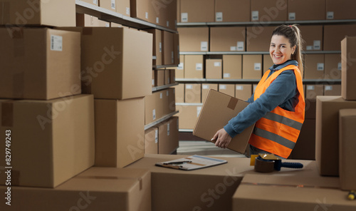 Portrait of a warehouse worker carrying a box