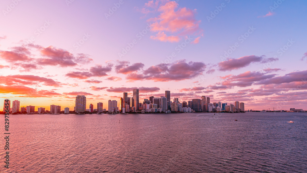 Fototapeta premium Scenic view of pink sunset in a modern city with skyscrapers