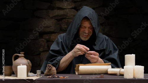 Monk counting money in stacks sitting at table 1 photo