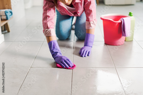 Woman cleaning the bathroom floor