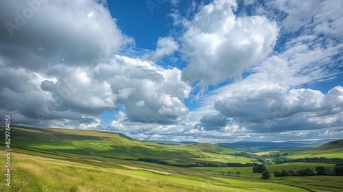 A picturesque countryside scene with rolling hills and valleys  framed by a sky filled with billowing cumulus clouds.