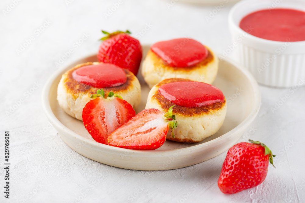 Vegan cheesecakes with strawberries, jam, cashew and tofu. Healthy breakfast. Syrniki, cheese pancakes.