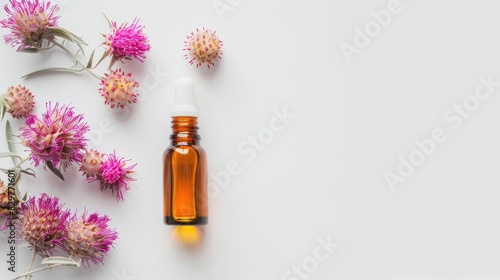 Top view of Castor serum oil and pink flower essential on a white background with space for product placement Concept of natural organic cosmetics