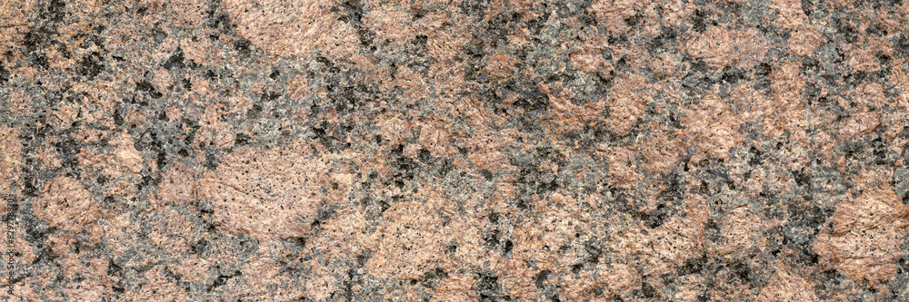 Granite texture. Natural pink granite with a grainy pattern. Stone background. Solid rough surface of rock. Durable construction and decoration material. Close-up. Granite texture. Natural pink granite with a grainy pattern. Stone background. Solid rough surface of rock. Durable construction and decoration material. Close-up.