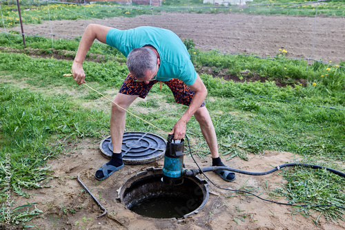 Pumping sewage from septic tank using submersible wastewater pump.