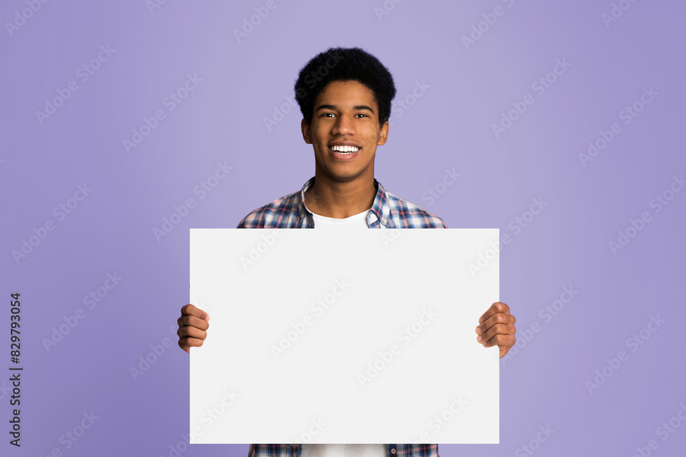 Happy guy showing blank placard with copy space for your text, pink background Happy guy showing blank placard with copy space for your text, pink background