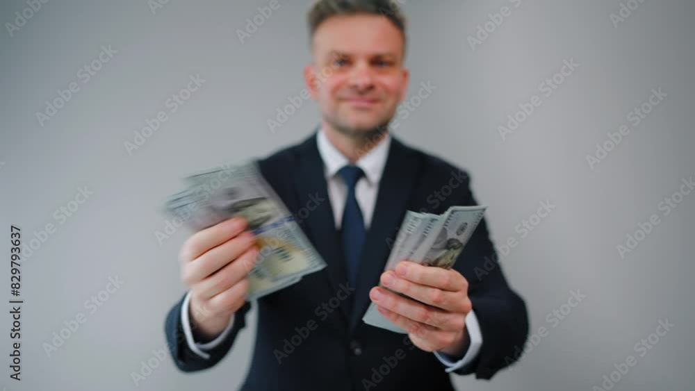 Formally dressed man is counting US Dollar bills quickly, close-up. Formally dressed man is counting US Dollar bills quickly, close-up.