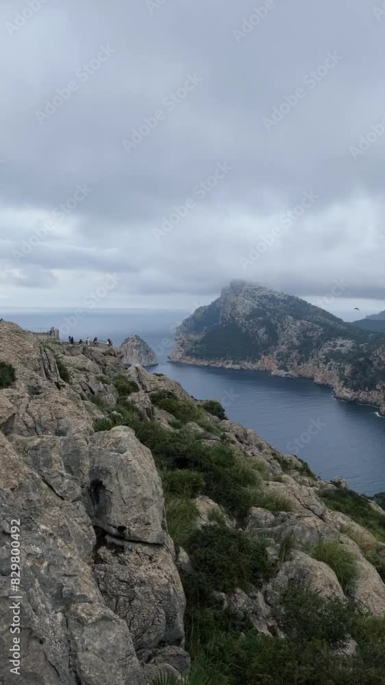 view of the edge of the island with high mountains in the sea view of the edge of the island with high mountains in the sea