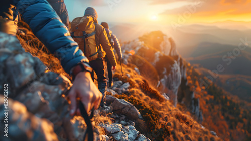 Close-up of Hiker helping friend reach the mountain top