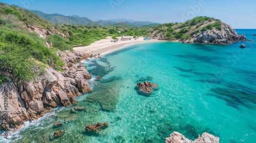 The secluded beach  surrounded by rugged cliffs and lush greenery  offers a tranquil escape. The crystal-clear waters invite swimmers and snorkelers to explore the vibrant marine life below.