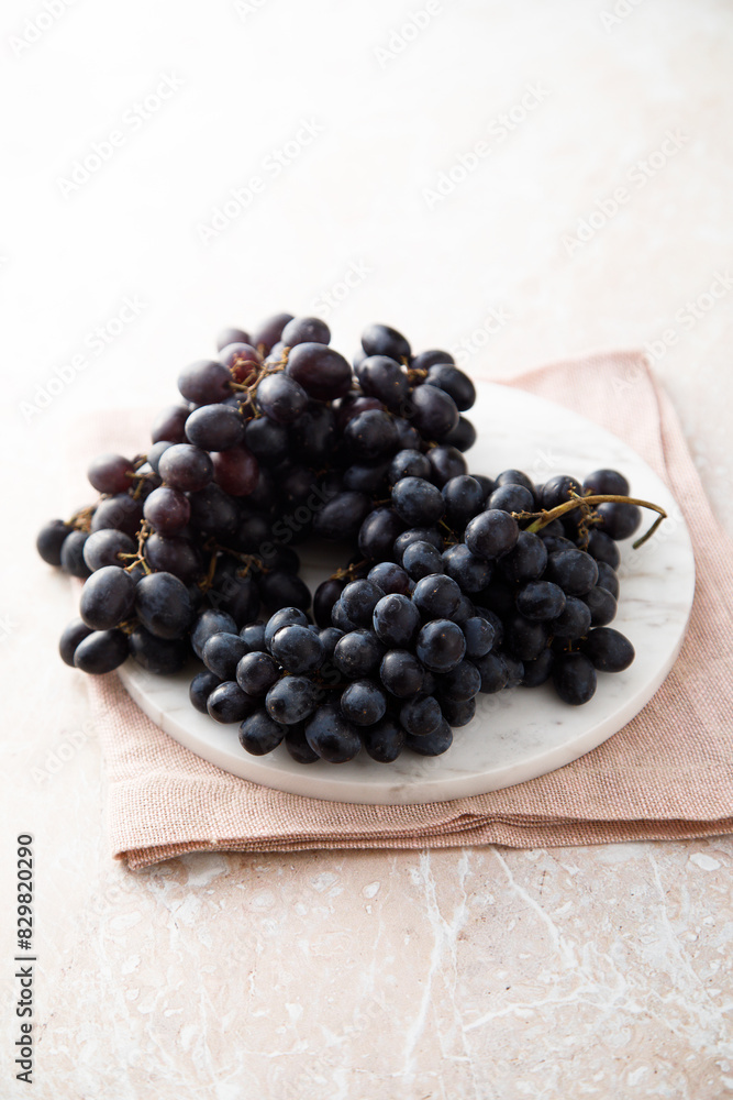 Dark grape on a white desk Dark grape on a white desk