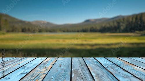 Empty wood table top with blur background of mountain and green nature. The table giving copy space for placing advertising product on the table along with beautiful forest nature scenery background.