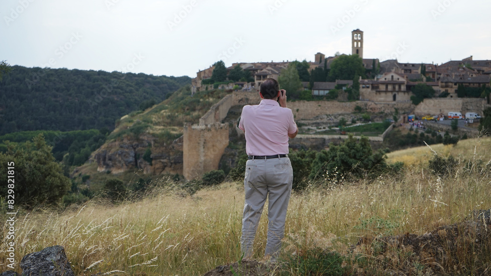 Fototapeta premium A person taking a photo of a medieval village