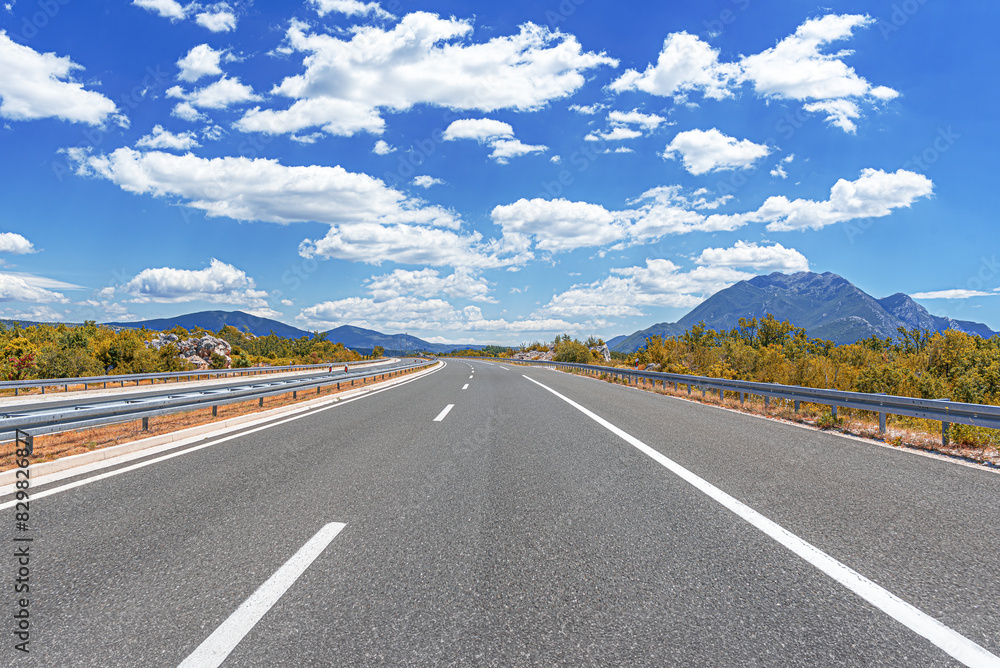 Country road with rocky mountains in the background. Country road with rocky mountains in the background.