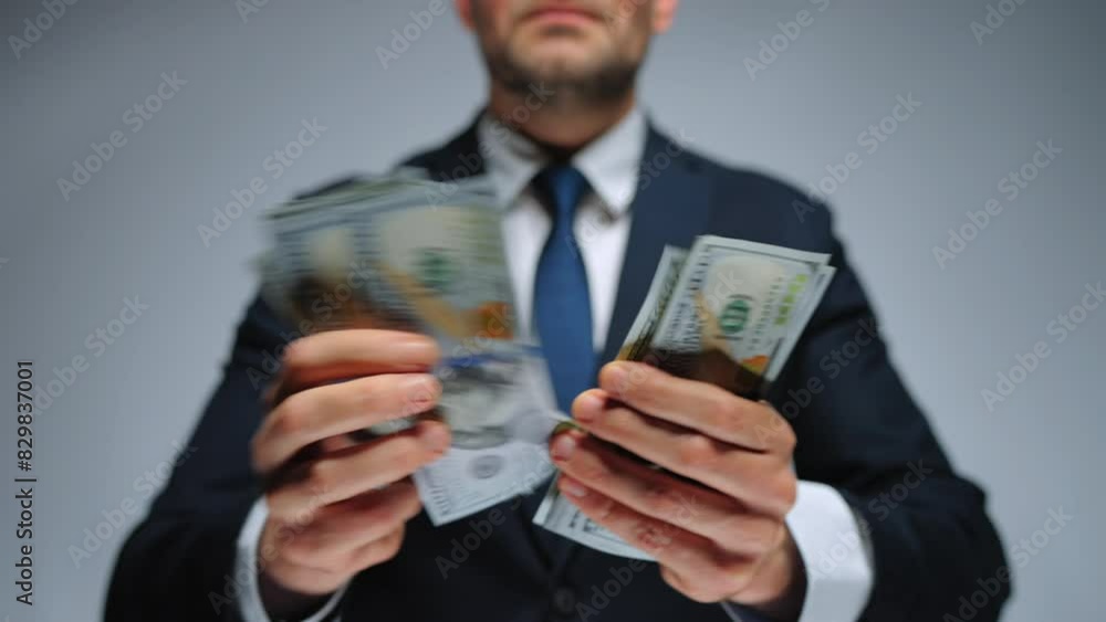 Formally dressed man counting US Dollar bills, close-up. Formally dressed man counting US Dollar bills, close-up.