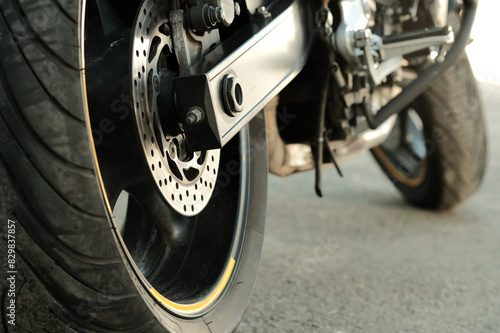 Motorsport. A sports motorbike. Side view from behind. The rear wheel is a close-up. The volume size of the tire.