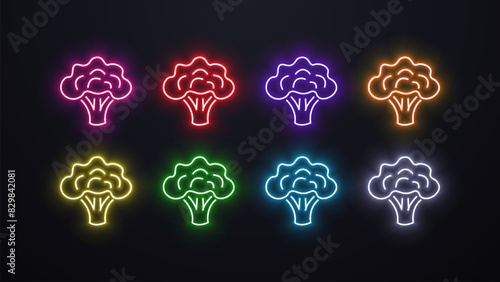 Neon bright broccoli icons in different colors on a dark background. The concept for veganism