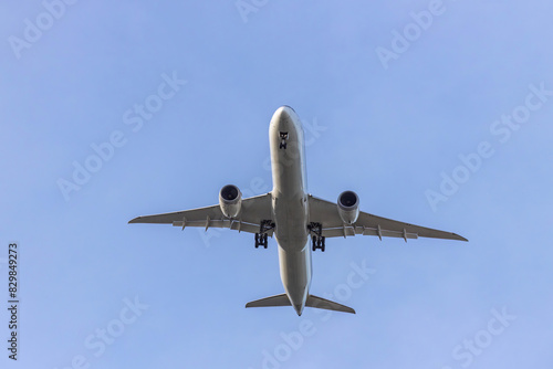 Airplane and sky, the plane is landing. Airplane take off on the blue sky, Aircraft flying on sky background. Passenger plane ready for landing. Low angle view of Airplane flying under blue sky.